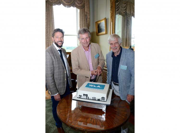 The directors of Williams Lester Architects cutting the cake